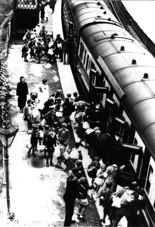 The arrival of teachers and children from West Ham at Chipping Norton station on 1 September 1939, with gas masks and labels